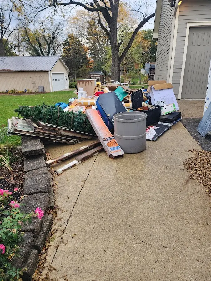 Dumpster being loaded with debris for Residential Dumpster Rental in Prescott